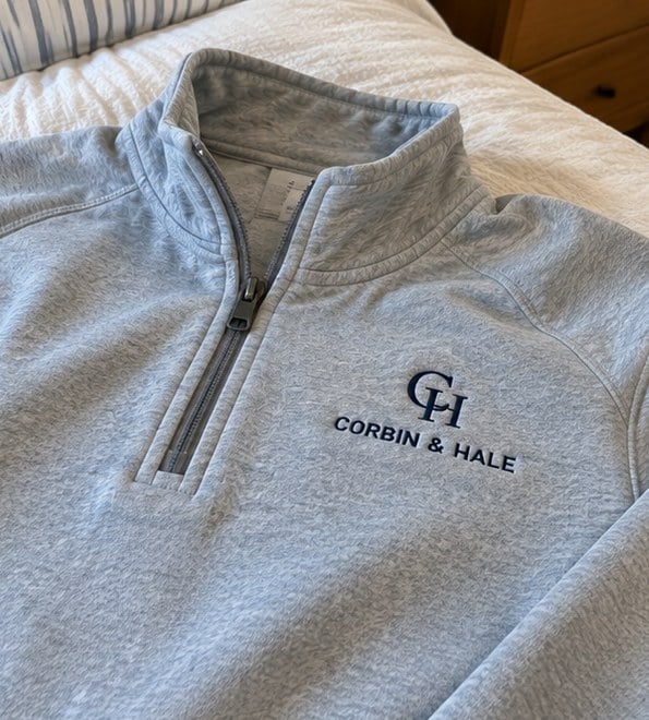 Customer photo of a custom quarter zip on a bed